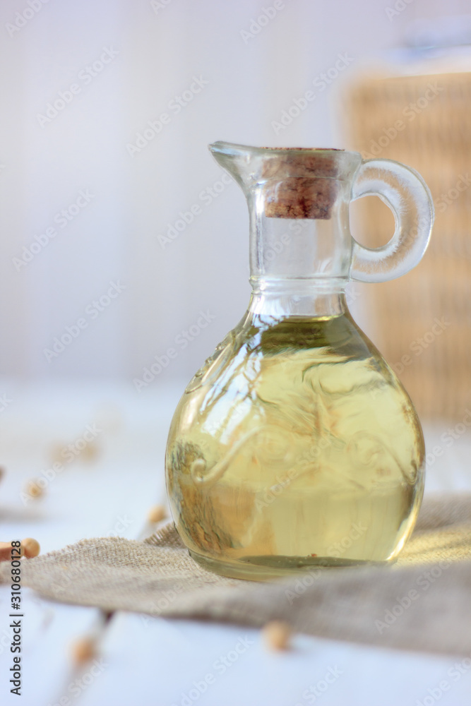 Soy bean oil in glass bottle with soybeans around it. Soy bean oil in glass bottle with soybeans around it.