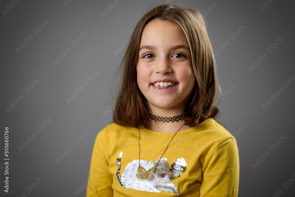 Portrait of happy young little girl with emotions on gray. Portrait of happy young little girl with emotions on gray.