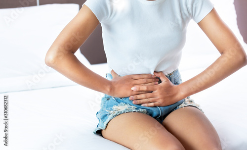 woman Hands holding belly Abdominal pain bowel health Problems