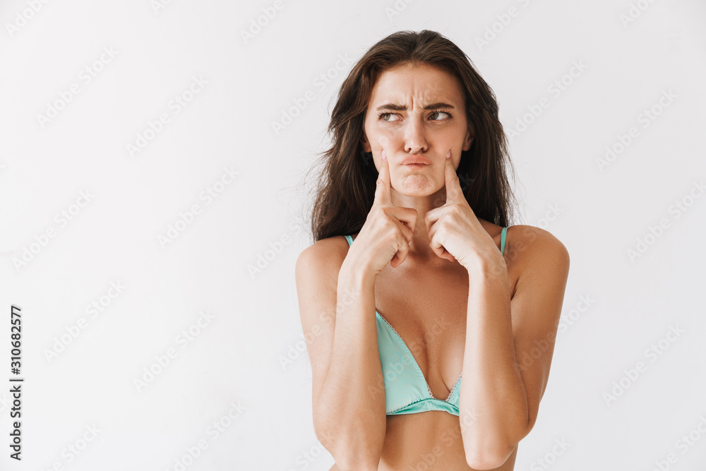 Beautiful young slim girl wearing bikini standing isolated Beautiful young slim girl wearing bikini standing isolated