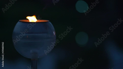Glittering golden bokeh of burning candles glowing in glass lantern at dark night with full moon. Concept with Buddhism and peace.  