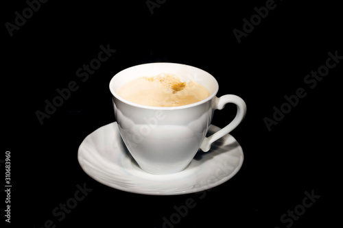 black coffee poured from a white mug on a dark background