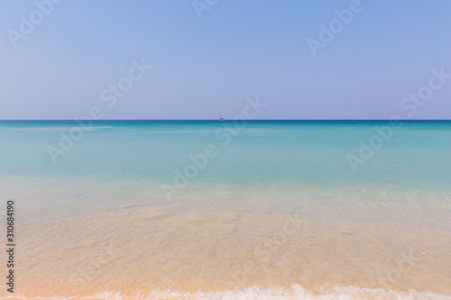 Beach scene, calm summer nature landscape. Blue sky and ocean waves