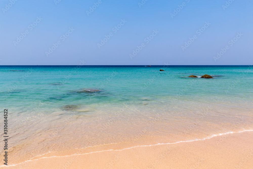 Beach scene, calm summer nature landscape. Blue sky and ocean waves