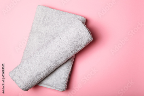 Fresh towels on a colored background with place for text top view.