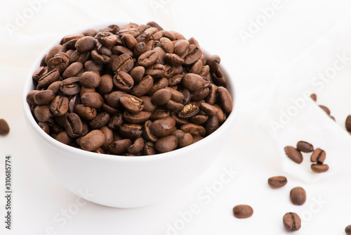 Bowl of caffee beans on a white background