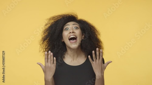 Oh my god I won. Attractive african american female hipster with pierced tongue, afro hair, hear great news, become champion, cant believe looking surprised, start dance as celebrating, triumphing