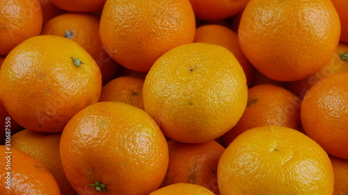 Bunch of fresh mandarin oranges on market, close-up