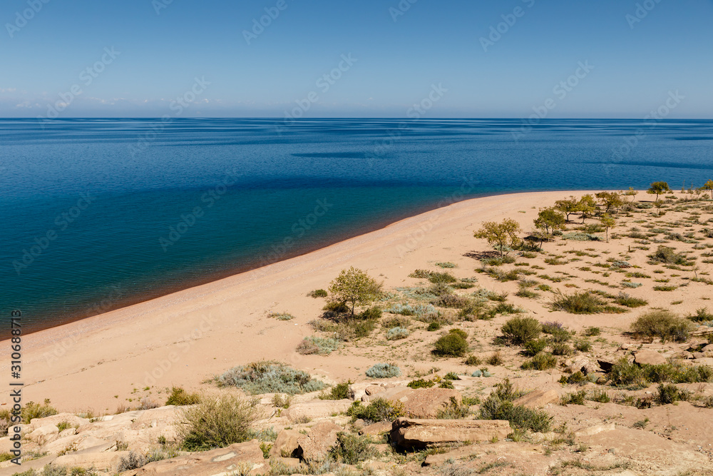 Lake Issyk-kul, empty sandy beach on the southern shore of the lake, Kyrgyzstan Lake Issyk-kul, empty sandy beach on the southern shore of the lake, Kyrgyzstan
