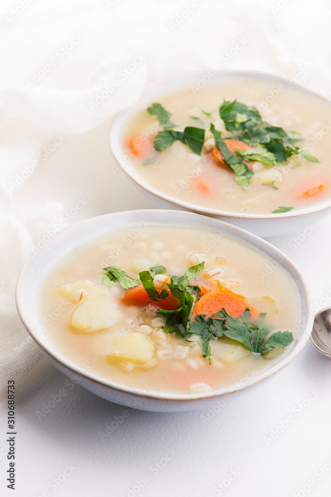 Barley soup, pearl barley in white bowl Barley soup, pearl barley in white bowl