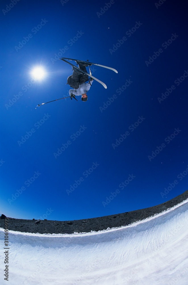 Skier Performing Flip On Mountain