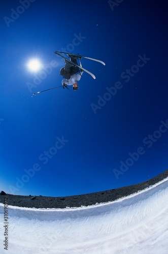 Fototapeta Naklejka Na Ścianę i Meble -  Skier Performing Flip On Mountain