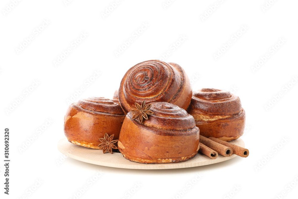 Tasty cinnamon roll with ingredients on plate isolated on white background Tasty cinnamon roll with ingredients on plate isolated on white background