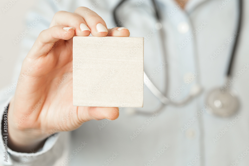 Close up image of medical worker holding blank card, health care and medicine concept with copy space Close up image of medical worker holding blank card, health care and medicine concept with copy space