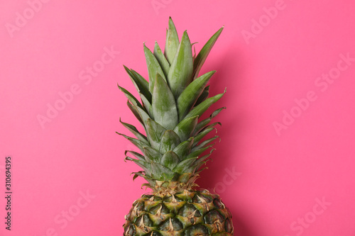 Pineapple on pink background  space for text. Juicy fruit