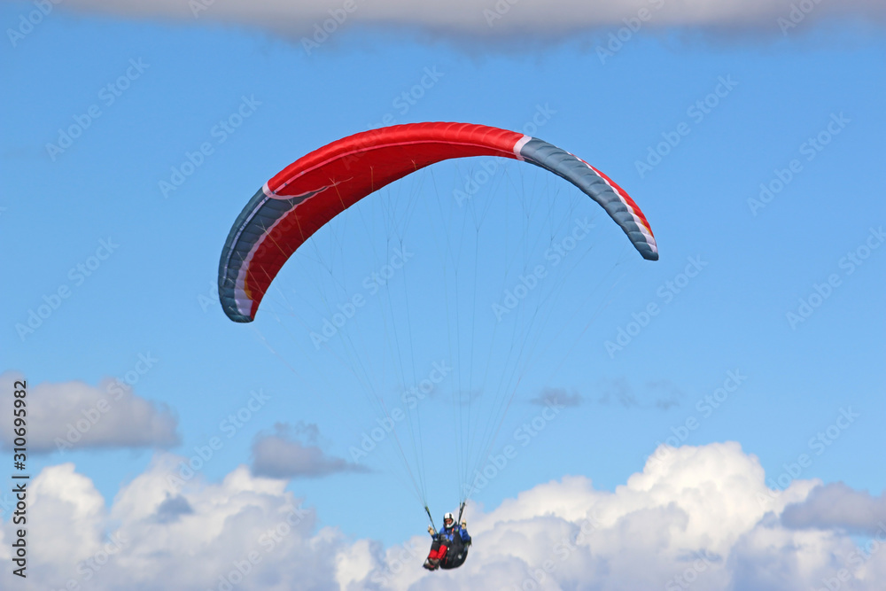 Paraglider flying wing in a blue sky	