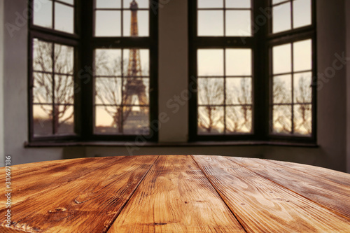 Dark wooden table of free space and window sill background with city landscape. 