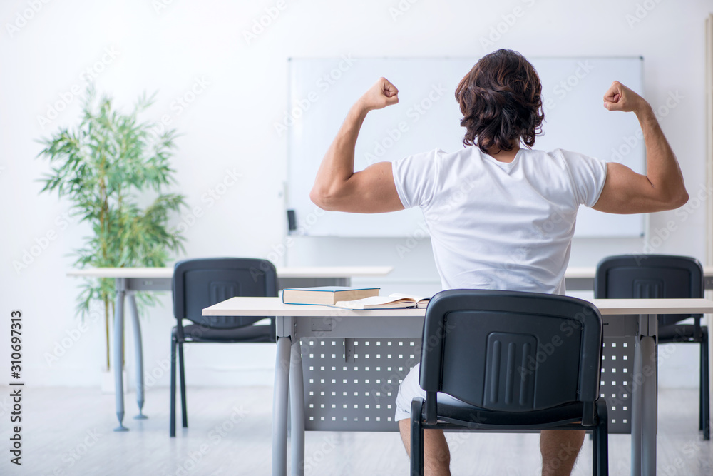 Young male student in front of whiteboard Young male student in front of whiteboard