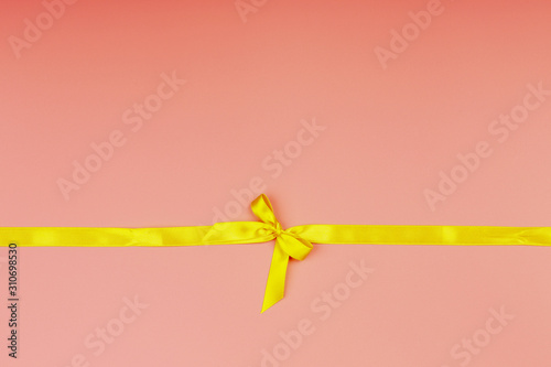 Christmas pink background. Yellow ribbon.