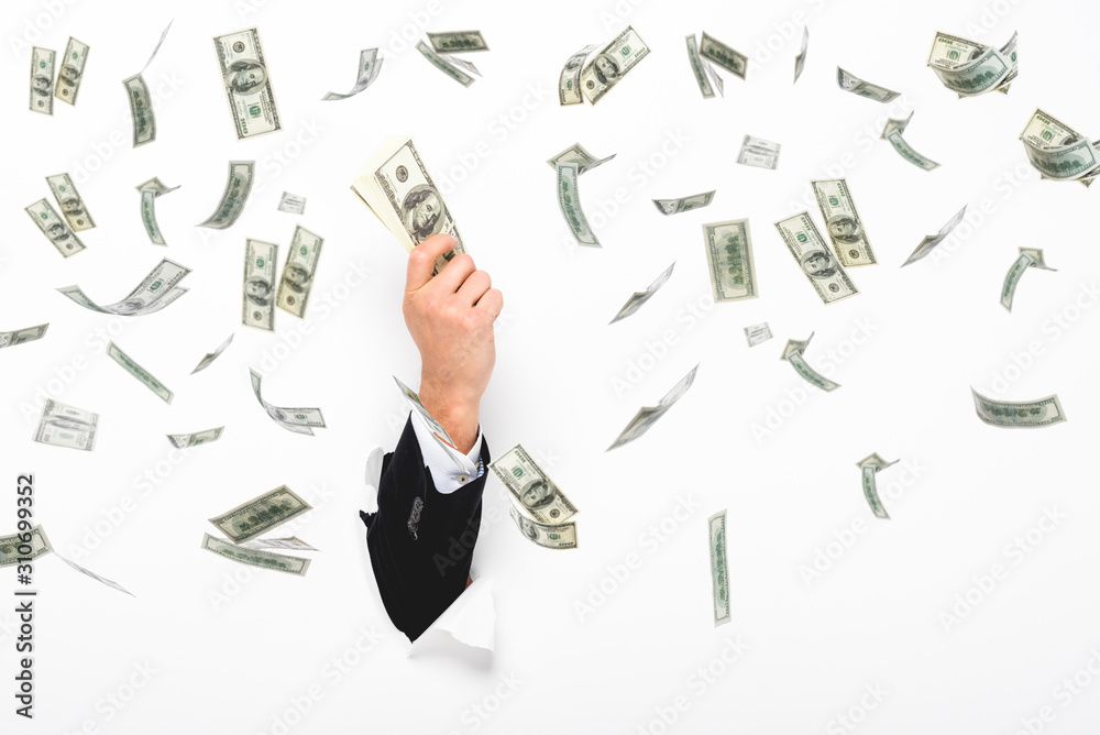 Cropped view of man holding money through hole in white paper wall on white with money rain illustration Cropped view of man holding money through hole in white paper wall on white with money rain illustration