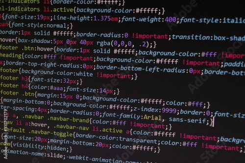 Close up css code on monitor screen with black background photo