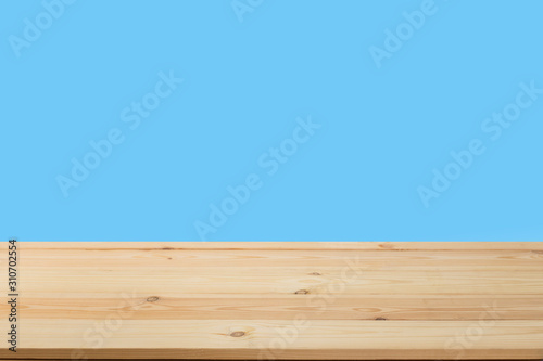 Wooden table in front of a blurred background. Perspective brown wood over blurred wooden planks background - can be used to showcase or assemble your products. Mock up to display the product.