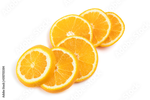 The juicy orange is cut across into round segments. The slices are folded in view of the timber on each other. White background