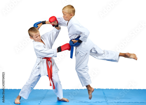 Two athletes train karate blows