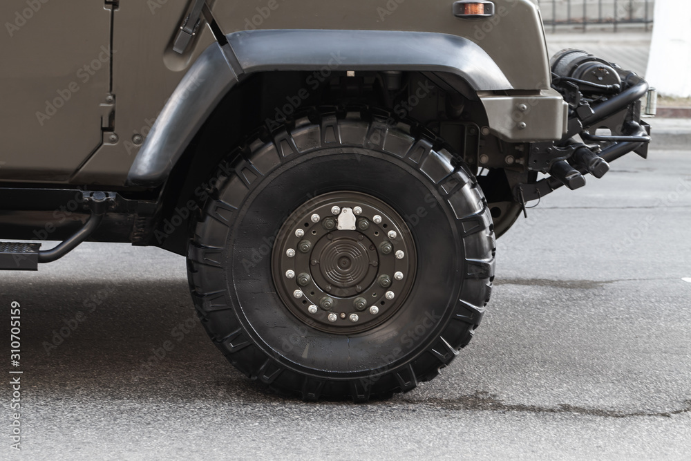Closeup photo of military car wheel on a road Closeup photo of military car wheel on a road