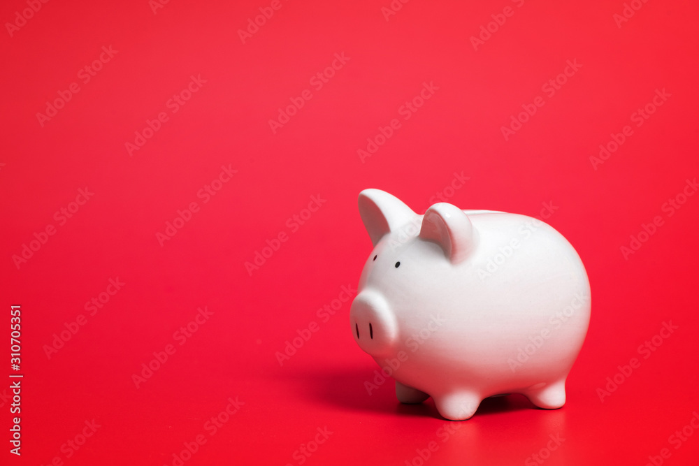 Composition with piggy bank isolated on red background. Composition with piggy bank isolated on red background.