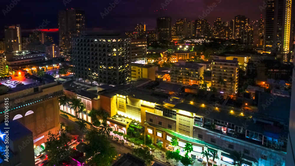 Obraz premium Colorful night life lights of Waikiki city from top overlook. Oahu island Hawaii, United States. City night lights and nightlife concept.