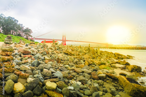 Photography Golden Gate Bridge moning sun in the fog from Crissy Field popular beach park for locals and tourists