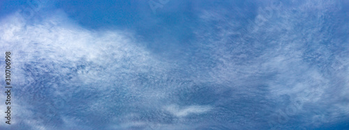 Fotografie Large panorama of odd and strange cloud textures in the middle of the day in fro