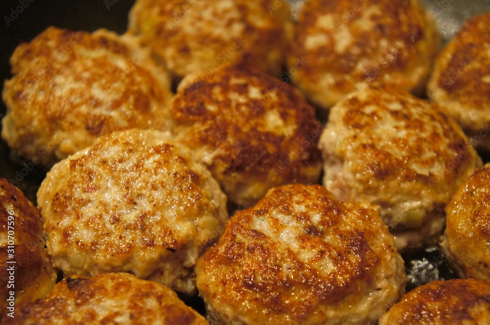 Fried meat cutlets rissole meatballs of minced pork in a pan.