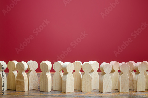 A crowd of wooden figures of people. Society, demography. Customers and buyers, statistics, preferences of Population. group of citizens, rally, political movement or electorate. Employees. Copy space photo