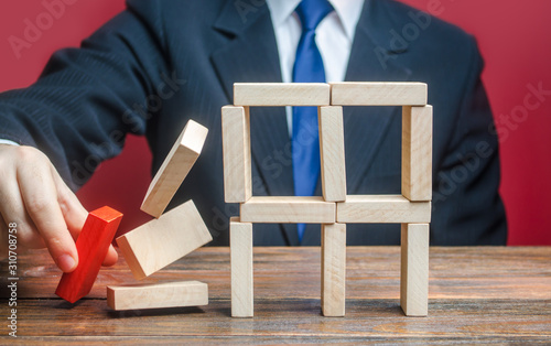 A businessman removes an important component causes collapse of entire complex system. Incompetent businessman. Making wrong decisions, ruining business. Inexperience, unprofessional leader. Failure