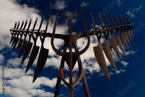 Morning sun on Spirit Catcher sculpture in Barrie Ontario against a blue sky with clouds photo