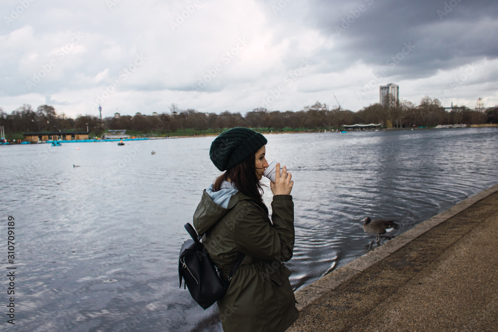 woman with coffee beside a lake woman with coffee beside a lake