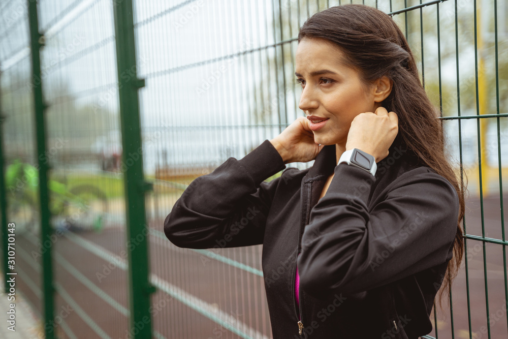 Cheerful longhaired female person preparing for exercises Cheerful longhaired female person preparing for exercises