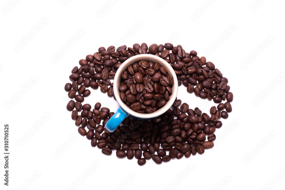 Coffee bean shape created with coffee beans and a mug Coffee bean shape created with coffee beans and a mug