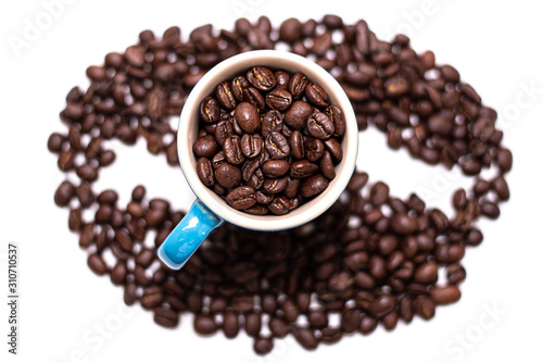 Coffee bean shape created with coffee beans and a mug