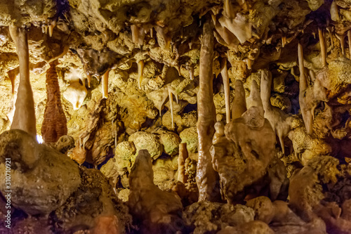 Various calcified formations, including stalactites and stalagmites, in a cave underground in Gozo island, Malta. photo