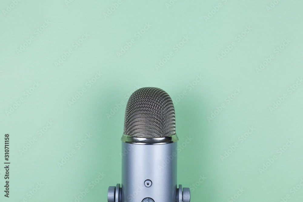 Closeup of professional microphone on mint background. Podcast studio concept. Electronic mic - obrazy, fototapety, plakaty 