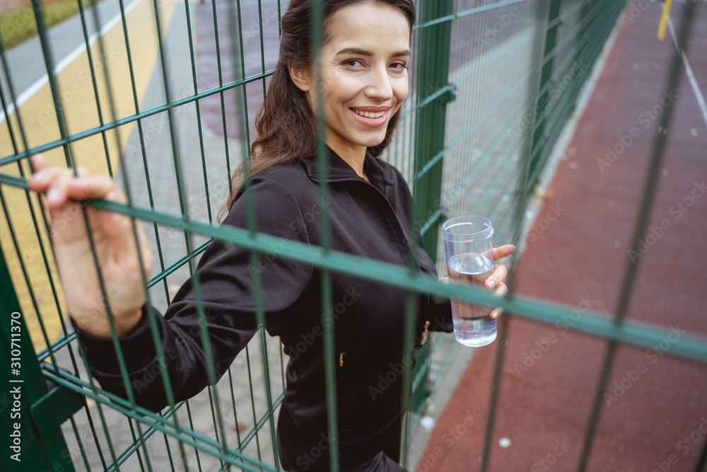 Fototapeta premium Cheerful young female looking straight at camera