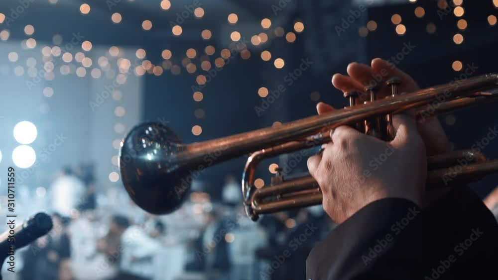 Trumpet player. Trumpeter hands playing brass music instrument close up. Detail of the player's fingers on trumpet. Close up of trumpet players fingers working the vavles