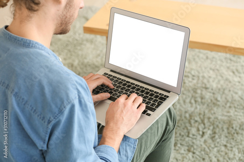 Handsome man with laptop at...