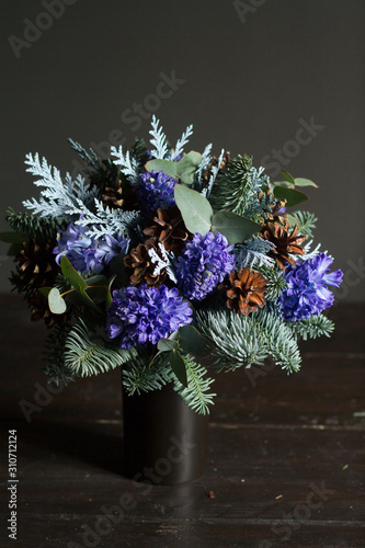 Winter bouquet of Nobil fir twigs, blue hyacinths and cones, winter gift concept photo