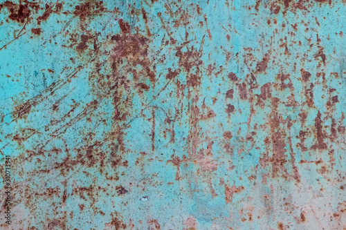 Texture of an old, dirty, rusty and heavily scratched and stained metal sheet once covered with blue paint