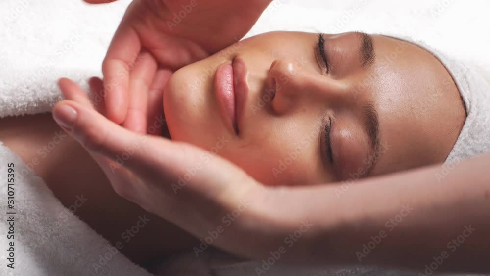 Face Massage in beauty spa salon. Skin care, wellness, beauty treatment.