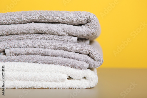 a stack of fresh towels on the table.